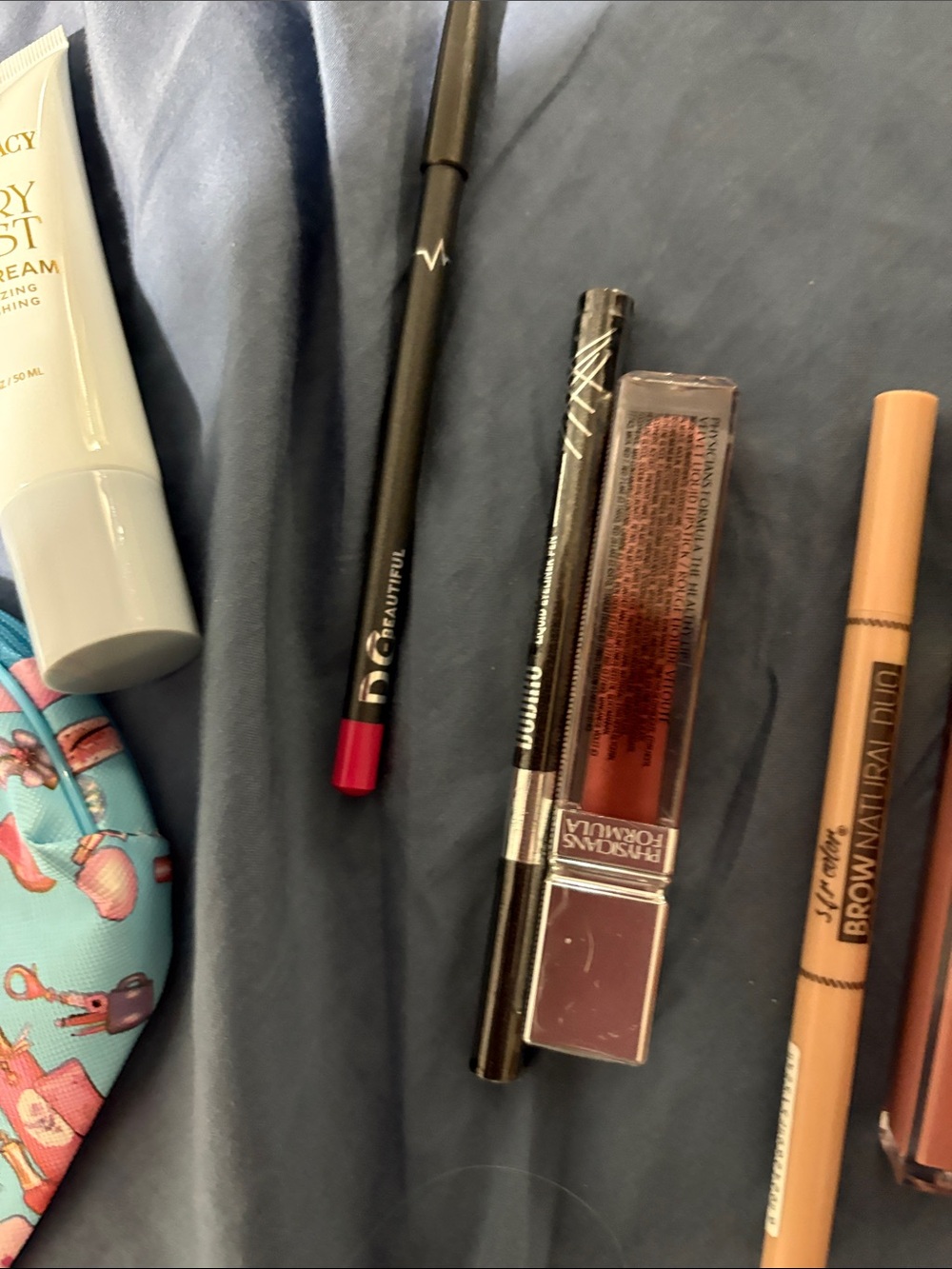 Blue Cosmetic Makeup Bag with Fun Print and assorted make up. - Picture 4 of 16